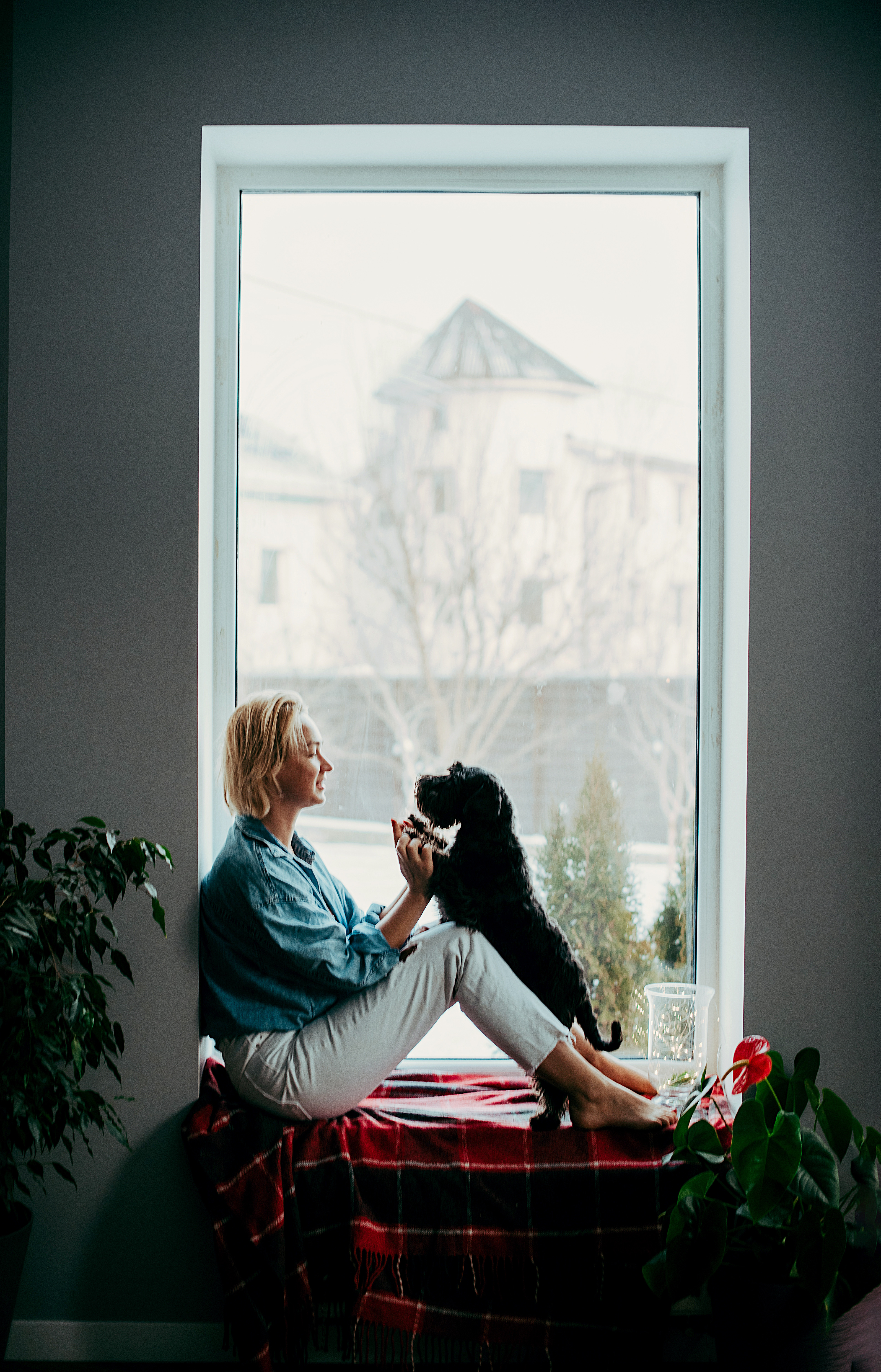 girl playing with dog at home